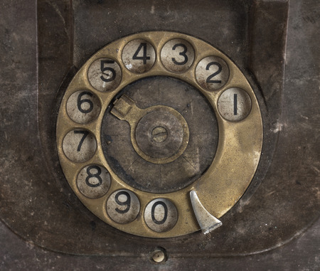 Closeup of vintage telephone dial, scratched and filthyの写真素材
