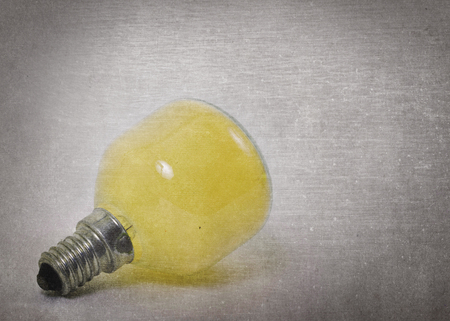 Old yellow lightbulb isolated on a white background - Vintage lookの写真素材