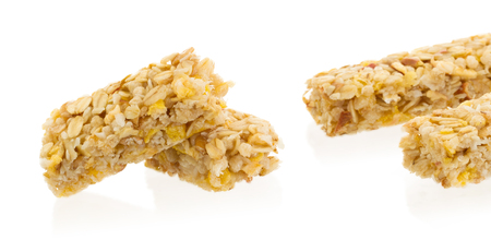 Muesli bar with apple, nuts and sugar isolated on whiteの写真素材
