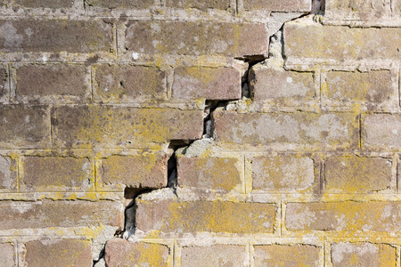 Background of old vintage dirty brick wall with peeling plaster, textureの写真素材