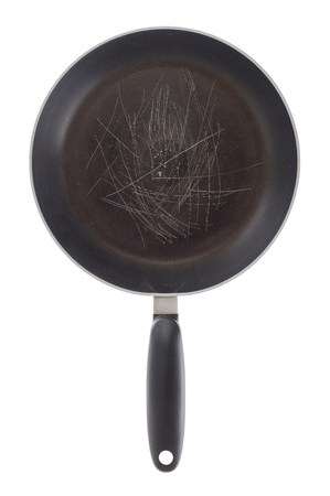 Broken old frying pan isolated on a white backgroundの写真素材