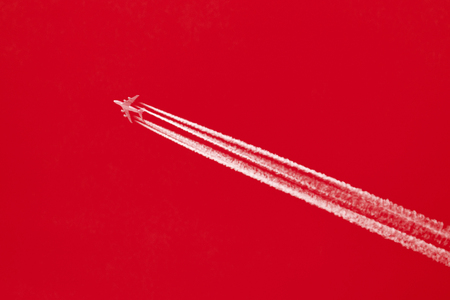 Large aircraft flying in sky, 4 stripes in the sky - Bright red skyの写真素材