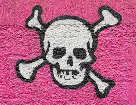 Simple black an white skull on a pink wallの写真素材