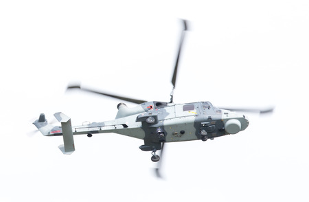 LEEUWARDEN, THE NETHERLANDS - JUNE 11, 2016: Royal Navy (Black Cats Display Team) Agusta Westland AW-159 Wildcat HMA2 performing some flights at the Royal Netherlands Air Force Daysのeditorial素材