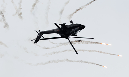 LEEUWARDEN, THE NETHERLANDS - JUN 10, 2016: Dutch AH-64 Apache attack helicopter firing off flares during the Royal Netherlands Air Force Daysのeditorial素材