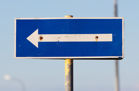Traffic sign arrow pointing left, sign on an abandoned Amarican Airforce base on Iceland