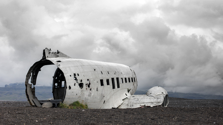The abandoned wreck of a US military plane on Solheimasandur beach near Vik, Southern Iceland -...