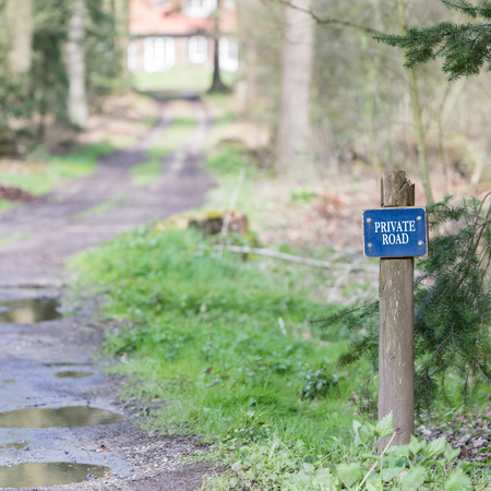 Private road sign with the forest on the backgroundの写真素材