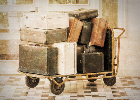 Trolley full of old luggage, vintage settingの写真素材