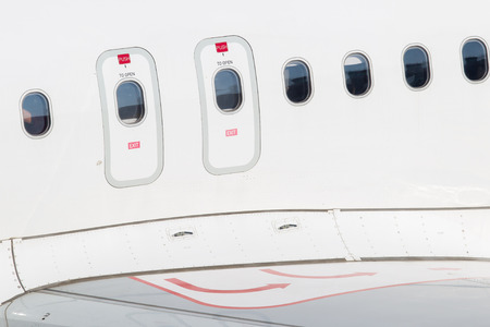Windows of airplane with emergency exit door