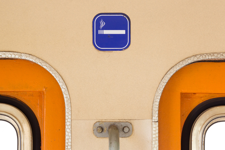 Close-up of a smoking sign in an old train carriageの写真素材