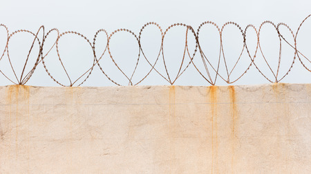 Barbed wire on top of a vintage wall