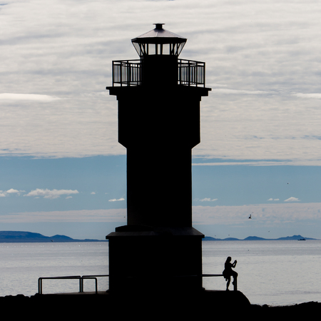 Seascape at sunset with a lighthouse, Icelandの写真素材