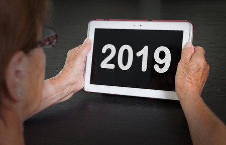 Senior lady relaxing and her tablet - New year - 2019