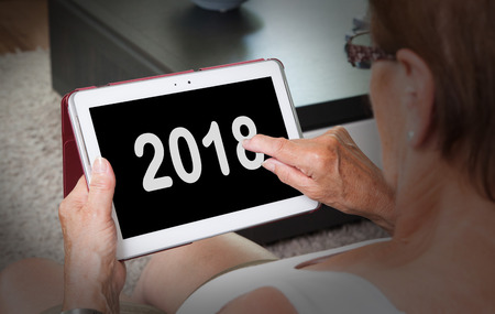 Senior lady relaxing and her tablet - New year - 2018の写真素材