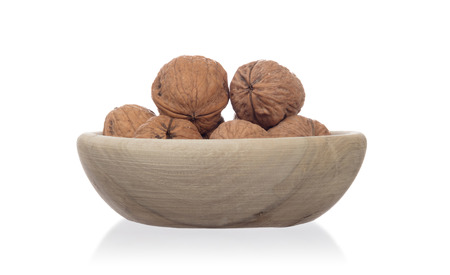 Wallnuts in a bowl, isolated on white