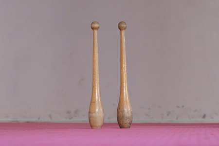 Two old wooden pins in a gymの写真素材