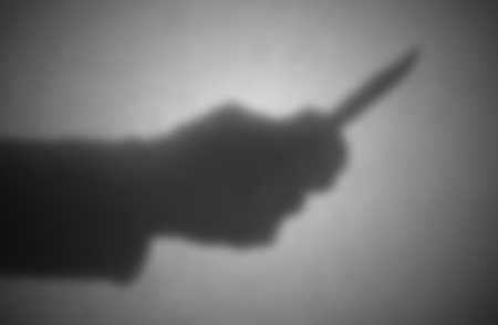 Silhouette behind a transparent paper - Blurred - Knife threatの写真素材