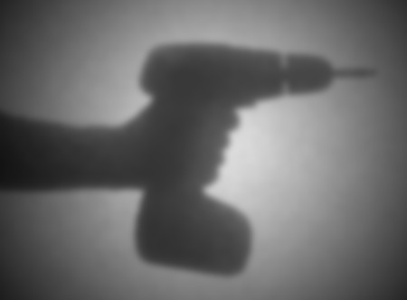 Silhouette behind a transparent paper - Blurred - Cordless drill