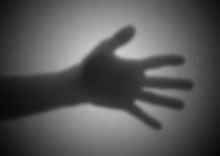 Silhouette behind a transparent paper - Blurred - Open handの写真素材