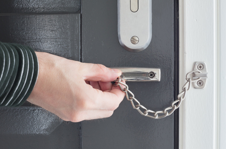 Door chain on a grey door, security measuresの写真素材
