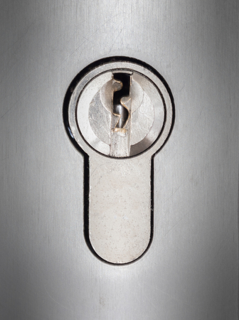 Cylinder lock closeup, shiny chrome, cylinder in the middleの写真素材