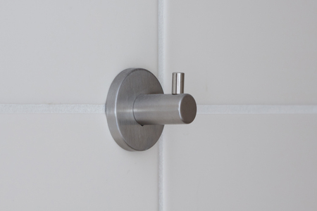 Strong steel wall hanger, white tile wallの写真素材