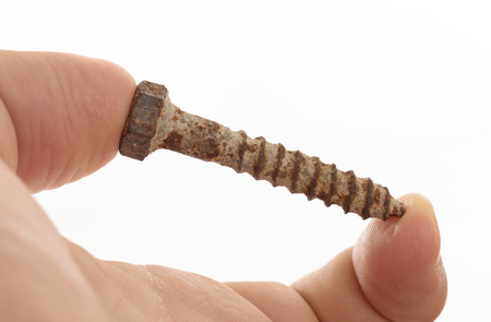 Rusted old screw isolated on white backgroundの写真素材
