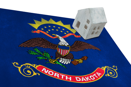 Small house on a flag - Living or migrating to North Dakotaの写真素材