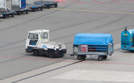 AMSTERDAM - JUNE 29, 2017: Planes are being loaded at Schiphol Airport June 29, 2017 in Amsterdam, The Netherlands. The airport handles over 45 million passengers per year with almost 100 airlines flying from here.のeditorial素材