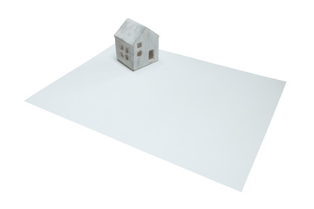 Small house on a white card, isoalted on whiteの写真素材