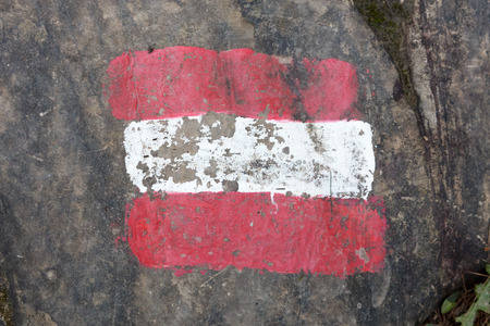 Walking path sign in Austria, flag painted on a rockの写真素材