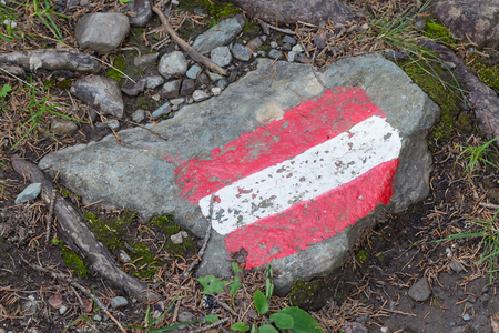 Walking path sign in Austria, flag painted on a rockの写真素材