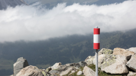 Walking path sign in Austria, flag painted on a poleの写真素材
