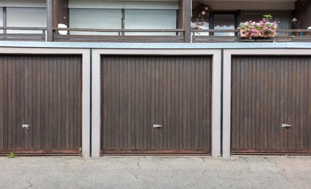 Old brown door of a garage, apartment complexの写真素材