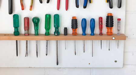 Assorted tools on a white tool board - Simple settingの写真素材