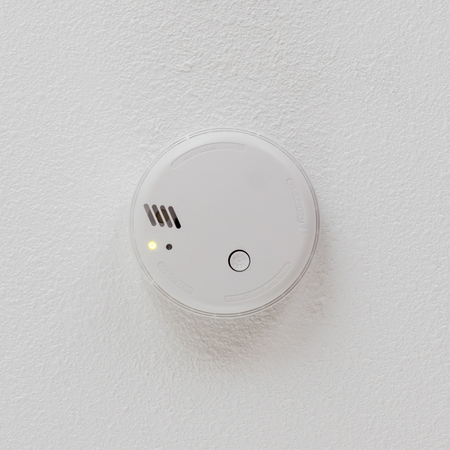 Smoke detector hanging on a ceiling - Private home