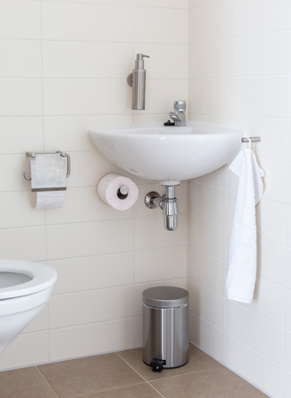 Hydrant and sink in a small toilet, used and slightly dirtyの写真素材