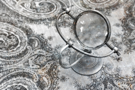 Vintage magnifier loupe  standing on a table  - Selective focusの写真素材