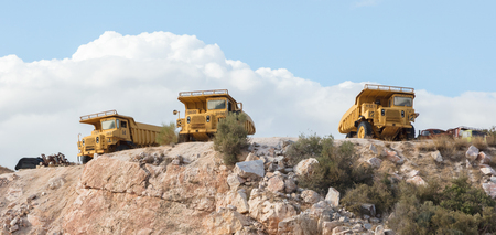 Old industrial trucks for stone waiting on a site in Greeceのeditorial素材