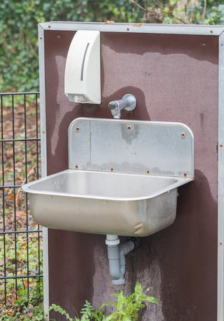 Metal sink outside - Washing your hands with soapの写真素材