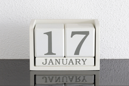 White block calendar present date 17 and month January on white wall background