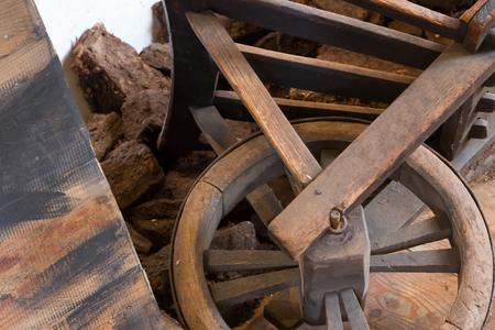 Old wheel on a wheelbarrow, selective focusの写真素材