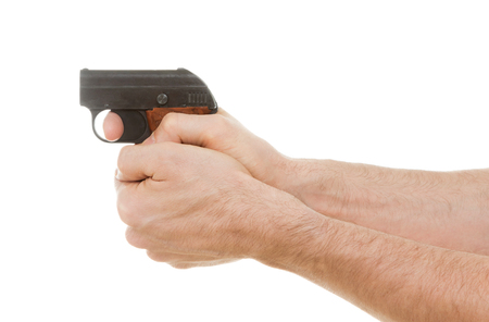 Small old alarm pistol in the hands of an adult manの写真素材