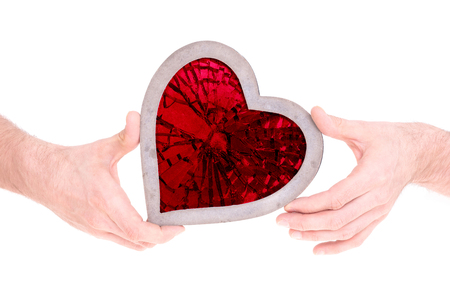 Adult holding heart filled with a large red ruby - Isolated on whiteの写真素材