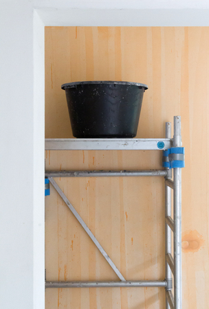 Worker tools - Bucket standing on rolling scaffolding (plaster work)の写真素材