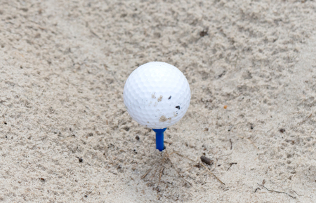 Golf ball waiting to be used, sandの写真素材