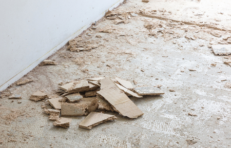 Construction concept - Jackhammer, removing chipboard from the floor - Selective focusの写真素材