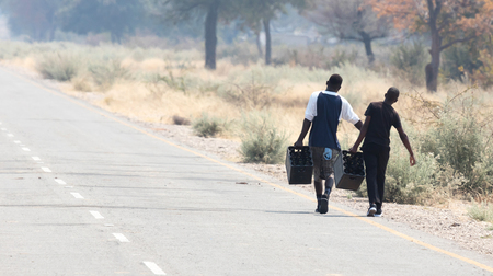 People walking at the side of the road, Namibiaのeditorial素材
