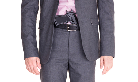 Man in suit with gun, handgun, isolated on whiteの写真素材